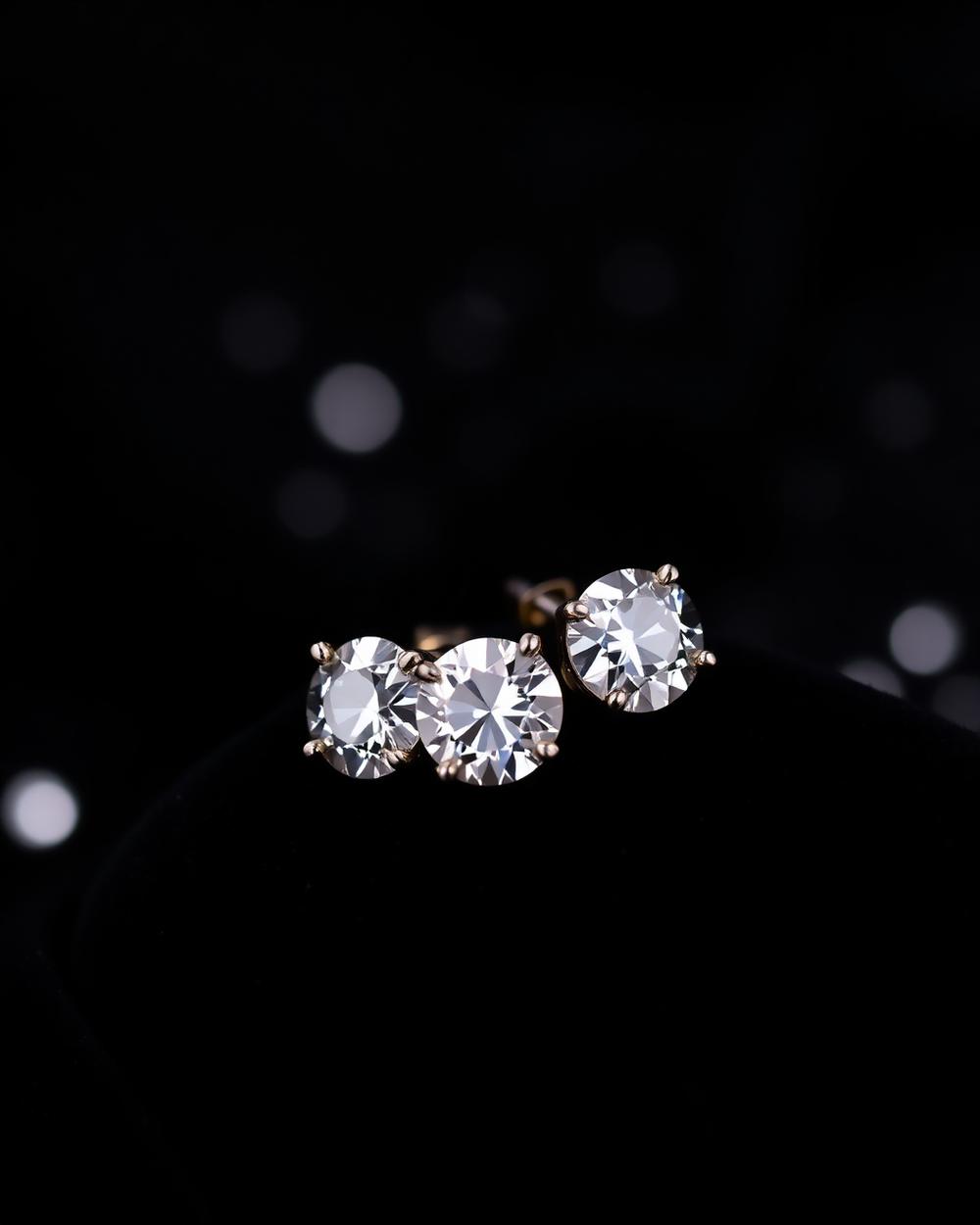 Diamond stud earrings on black velvet